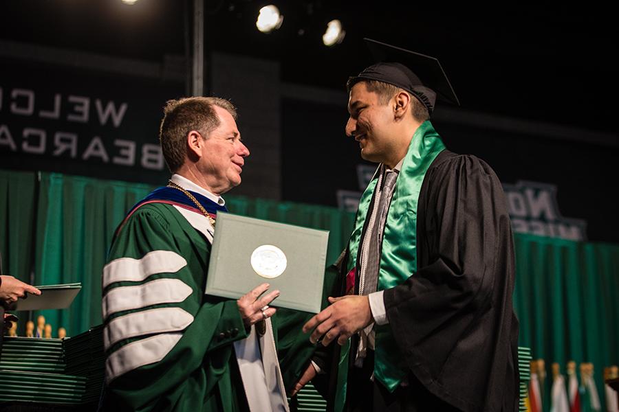 Northwest President Dr. Lance Tatum congratulates Didar Orazgeldiyev, who graduated with a bachelor’s degree in digital media with a visual imaging emphasis, on the commencement stage Friday afternoon. (Photos by Lauren Adams/Northwest Missouri State University)